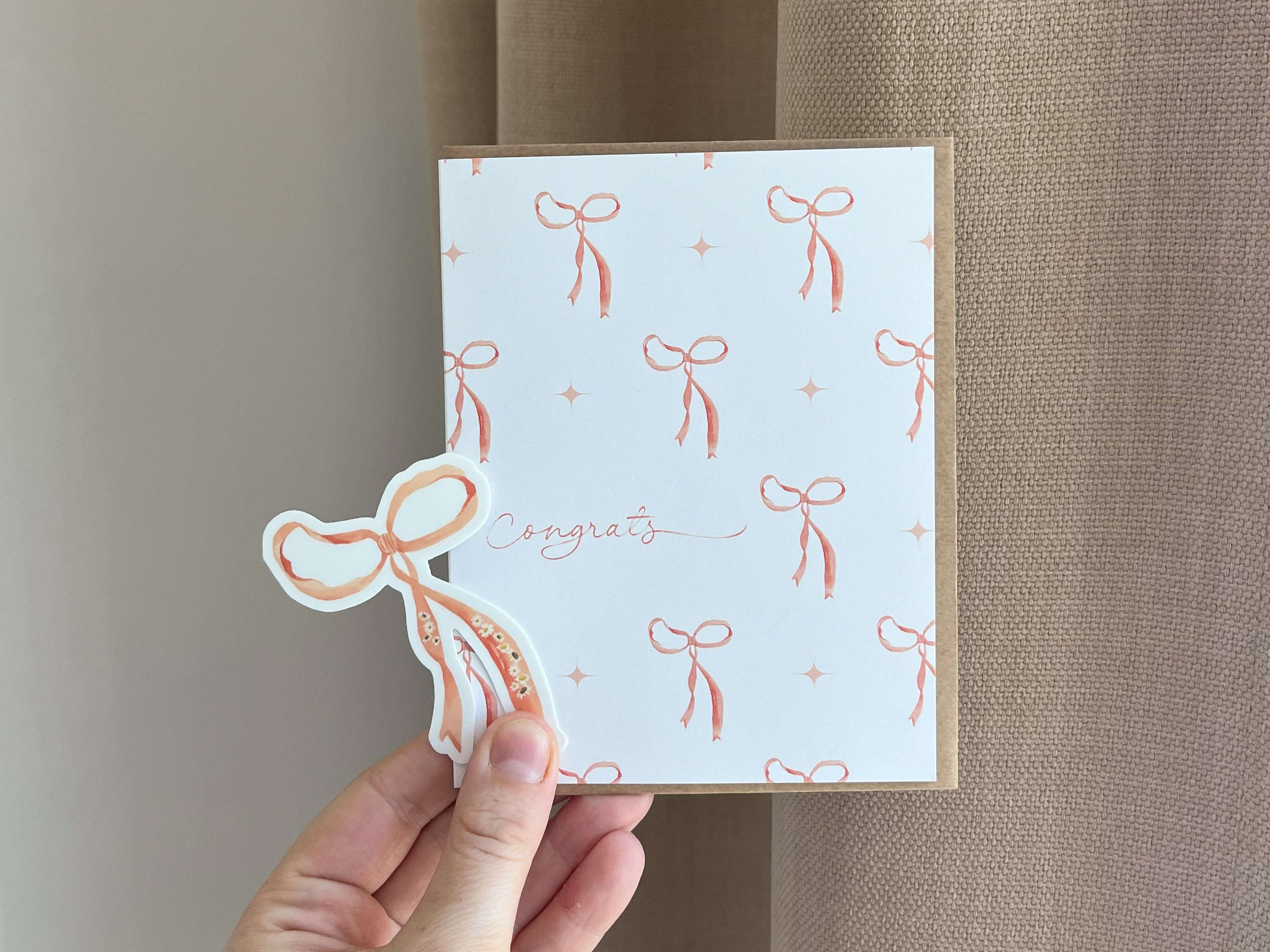  Coquette Congrats Card offers a perfect mix of charm and celebration. It's sure to bring a smile to a new homeowner, graduate, or newly engaged individual 